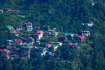 Remote Himalayan mountain village with traditional and modern houses on steep slope