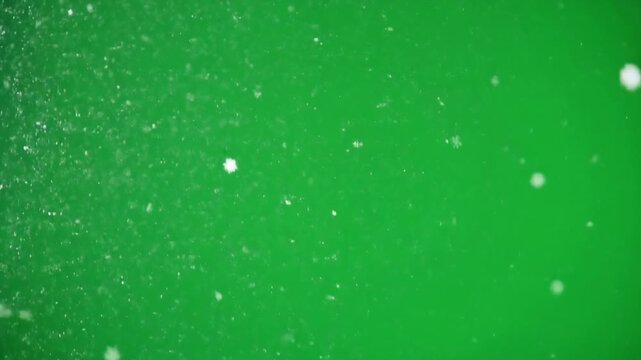 High definition stock video footage of small white particles or bubbles moving over a green screen background.&nbsp;This effect is very suitable for use as an overlay, background, orw