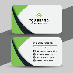 Modern professional business card design with green and black curved accents and white background for contact information