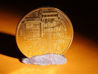 A gold coin with a circuit board on it