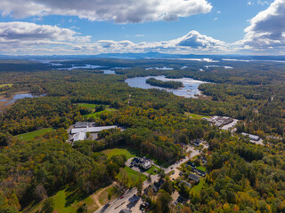 Aerial view of Lake Winnipesaukee with sunshine through clouds in fall from town of Moutonborough, New Hampshire NH, USA. 