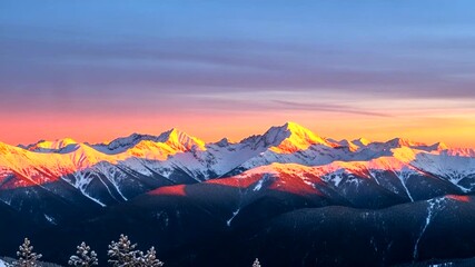 Majestic mountain range bathed in golden light at sunrise, capturing the snowy peaks and dramatic - Powered by Adobe