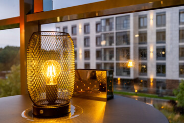 Cozy glazed balcony with panoramic windows evening light and view of a residential complex