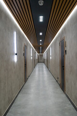 Modern corridor with doors and linear LED lighting