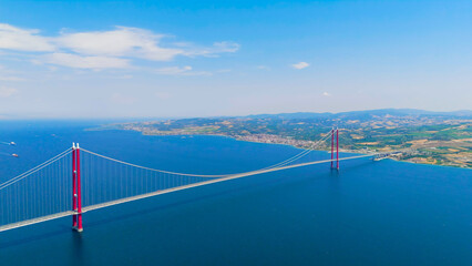 Fototapeta premium Lapseki, Turkey. Tourist cars and buses crossing the 1915 Canakkale Bridge over the scenic Dardanelles strait to Anatolia. Aerial View
