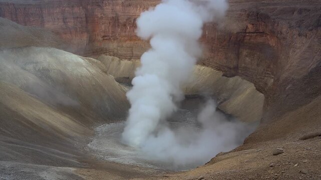 Steam from a Deep Canyon. Rising Wall of Endless Smoke/Steam Loop. A panoramic view of an immense, dry canyon. A column of heavy, moist white steam rises from the canyon floor.
