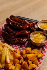 BBQ pork ribs with fries on a checkered tray
