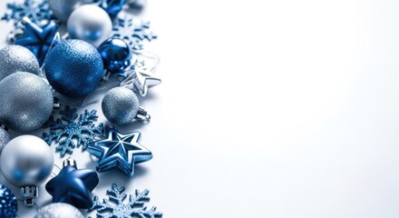 Blue and silver baubles, stars, snowflakes decorate left edge on a clean white background