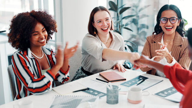 Women, meeting or applause with handshake for deal, business agreement or promotion in office. Female people, employees or colleagues shaking hands with smile or team for congratulations or thank you