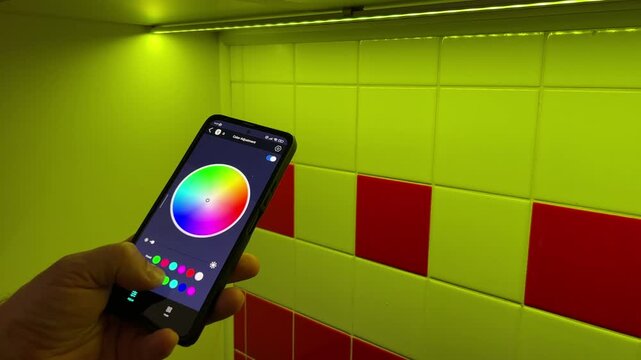 The LED Line Light in an aluminum profile glows a yellow RGB color. Change the color of the light using the smart home app on smartphone