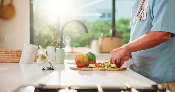 Man, hands and vegetables with tablet, food or meal prep for healthy cooking tutorial in kitchen. Male person, chopping or preparation with technology, flare or ingredients for organic recipe or diet