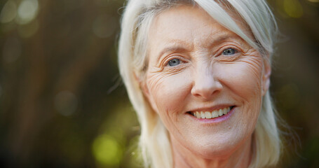 Portrait, smile and relax with old woman in nature for space, summer vacation and retirement. Happiness, peace and wellness with senior person outdoor in park for confidence, weekend break and calm