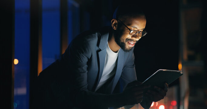 Tablet, happy and businessman in city at night with communication for finance review. Digital technology, bokeh and African male financial manager with email for investment proposal in urban town.