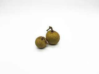 Two fresh longan fruits isolated on a white surface in a studio setting