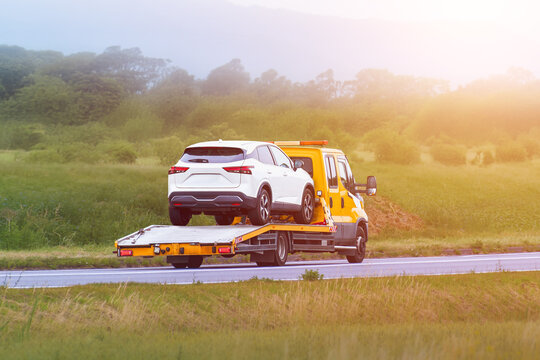 White car on flatbed after breakdown