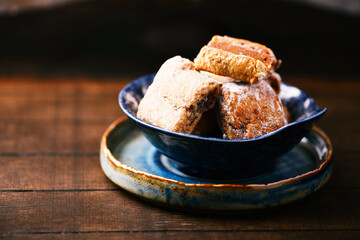 Traditional christmas cookies with gingerbread in a bowl on a rustic wooden background. Soft focus.	