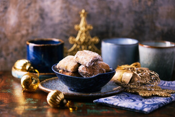 Traditional christmas cookies in a bowl on a rustic wooden background. Soft focus.	