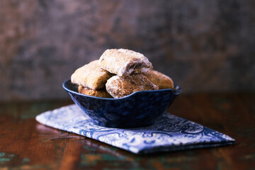 Traditional christmas cookies with gingerbread in a bowl on a rustic wooden background. Soft focus.	