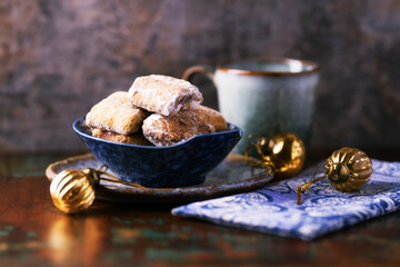 Traditional christmas cookies in a bowl on a rustic wooden background. Soft focus.	