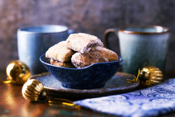 Traditional christmas cookies in a bowl on a rustic wooden background. Soft focus.	