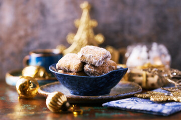 Traditional christmas cookies in a bowl on a rustic wooden background. Soft focus.	