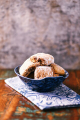 Traditional christmas cookies in a bowl on a rustic wooden background. Soft focus.	