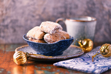 Traditional christmas cookies in a bowl on a rustic wooden background. Soft focus.	