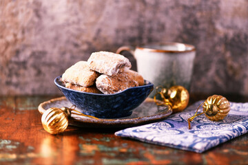Traditional christmas cookies in a bowl on a rustic wooden background. Soft focus.	