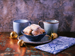 Traditional christmas cookies in a bowl on a rustic wooden background. Soft focus.	