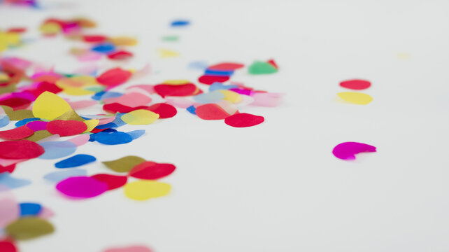 Bright multi-colored confetti lies on a clean white surface, adding joy to any celebration or event Generative AI