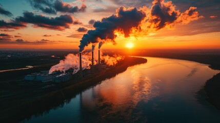 Industrial smokestacks billow smoke over a river at sunset (1)