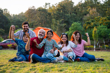 Indian family smiling together while camping and enjoying relaxed outdoor moments