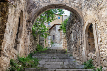 stone staircase passing under an arch  and climbing in an old village Navelli in the Abruzzi and partly abandoned Italy