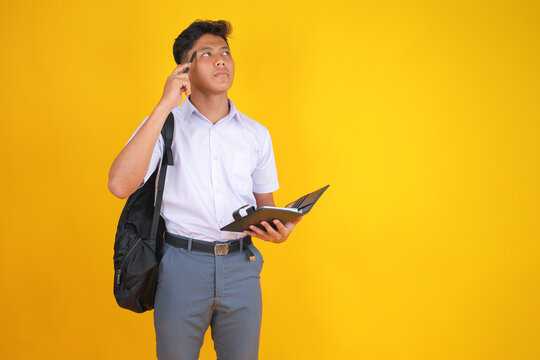 Pensive Student with Notebook and Pen Thinking About Education