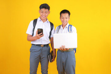 Two Cheerful Students Using Technology in School for Education and Learning