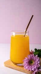Refreshing Orange Drink with Metal Straw and Beautiful Flower Arrangement on Wooden Coaster