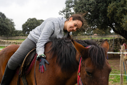 Woman bonding with horse outdoors, showing friendship - Powered by Adobe