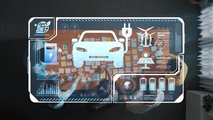A top-down view of a collaborative workspace, showcasing a digital interface for electric vehicle development with elements of renewable energy and team brainstorming activities. Raster