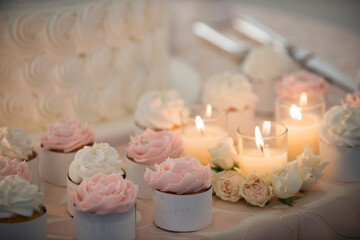 Pink and White Cupcakes with Candles and Roses on Wedding Table