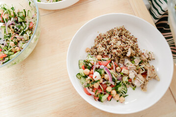 Overhead shot of quinoa salad bowl with chicken and veggies