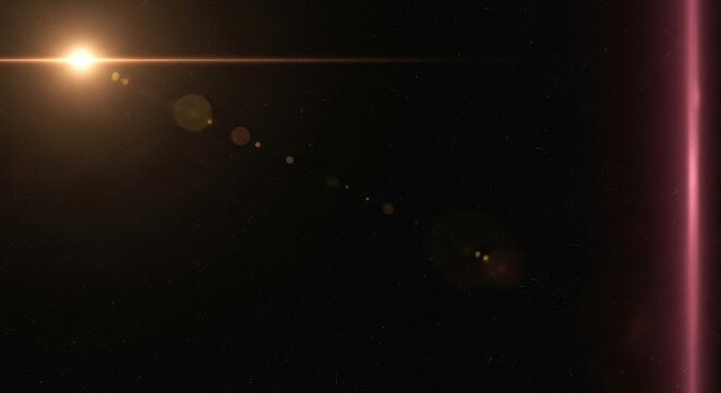 Dynamic bright lens flare effect with golden light streaks and glowing particles on a dark space