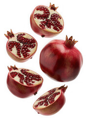 Fresh pomegranates whole and halved isolated on black background isolated on transparent background