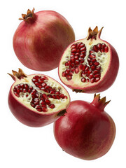 Whole and halved pomegranates with visible arils on black background isolated on transparent background