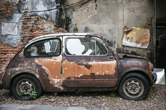 Old vintage wrecked car in the street of Bangkok, Thailand