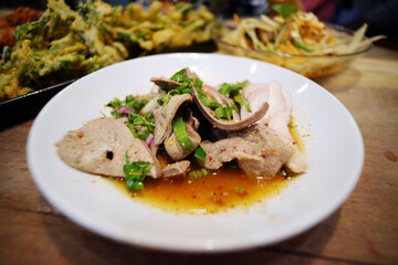 Pork liver spicy salad in white plate. Thai food