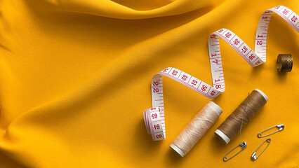 Sewing accessories on fabric. Concept: fashion, product creation, designer's work, and the creative...