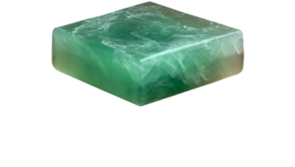 Translucent green crystal block with fluid-like surface texture isolated on transparent background