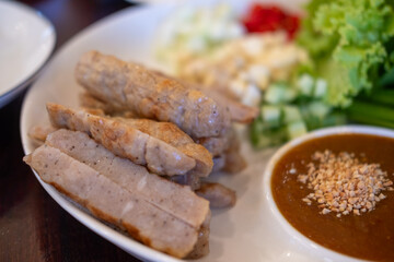 Naem Nueng or Nam Nuong, a Vietnamese style meatballs which is wrapped in rice paper and several fresh herbs and vegetables.
