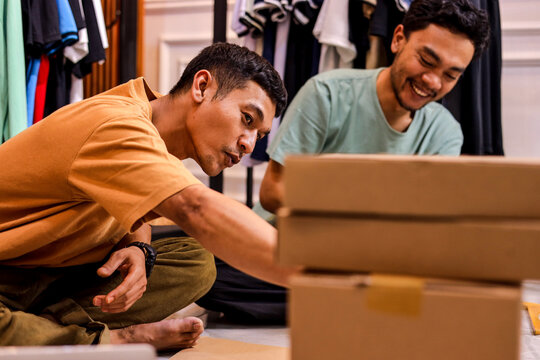 Young Entrepreneurs Collaborate Joyfully Packing Orders - Powered by Adobe