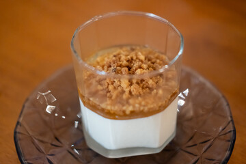Panna Cotta in a glass cup, on the table in the restaurant